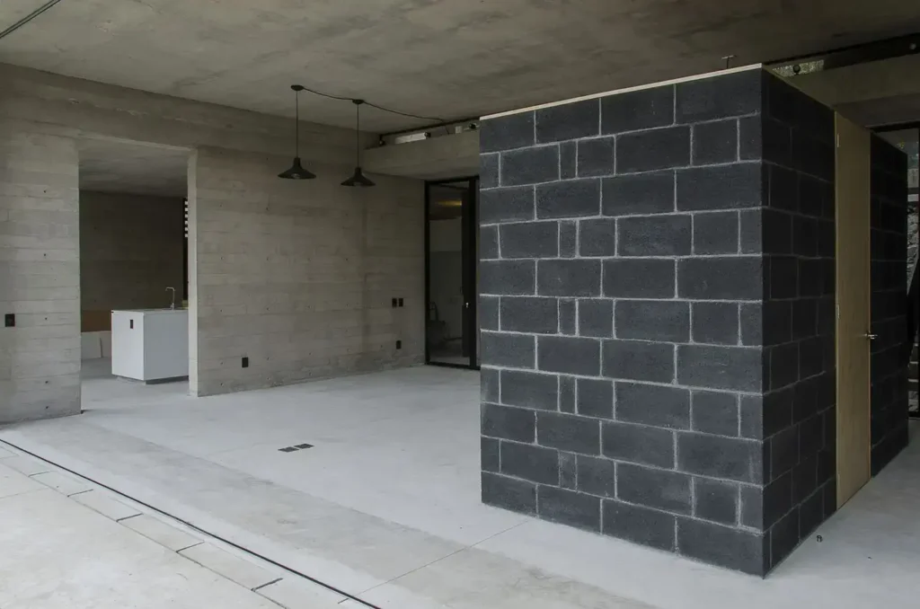 Interior with concrete walls and black cinder block structure.