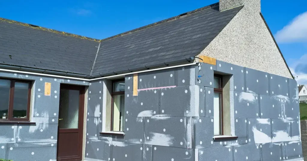 A house with a large window, highlighting external wall insulation for better energy efficiency.