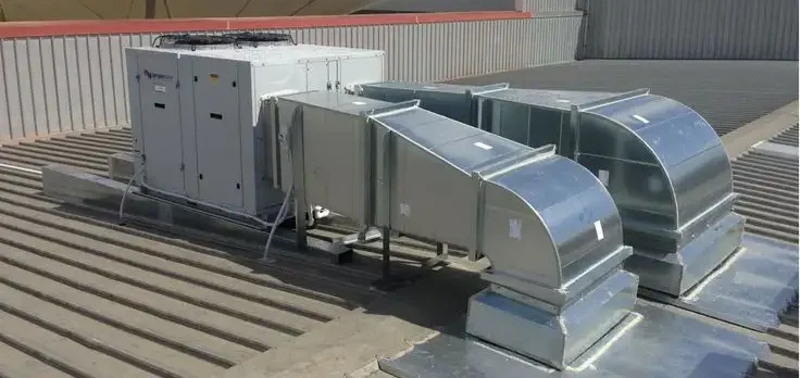 HVAC system installed on a rooftop with visible ductwork and air handling units, providing heating, ventilation, and air conditioning for the building.