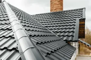 metal roof with black corrugated panels and a brick chimney.