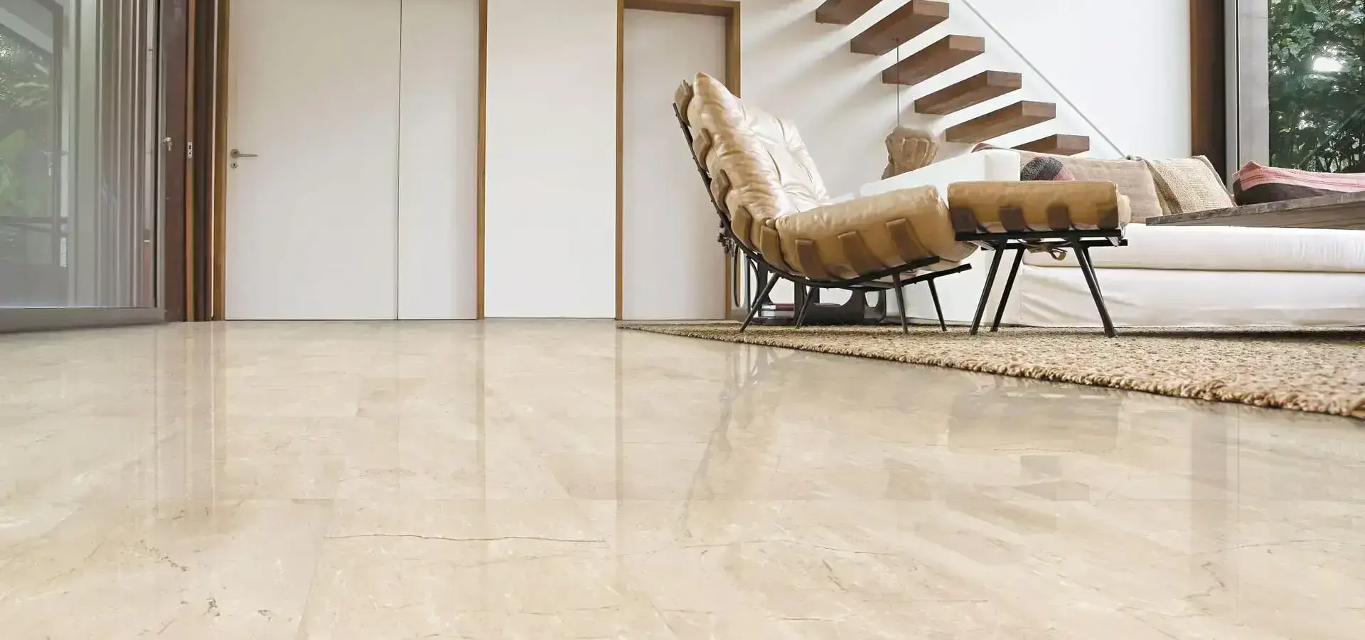 Polished marble flooring in a sleek, modern interior with natural light and minimal decor.